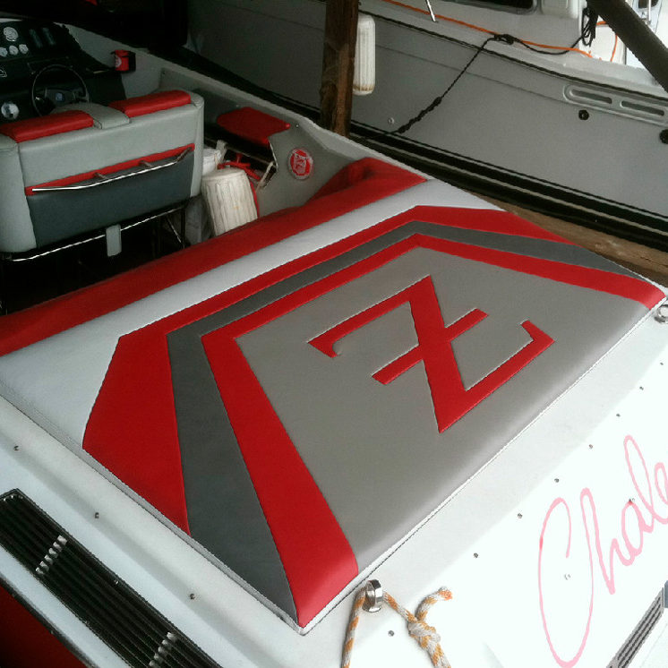 Red and grey custom marine upholstery for a rear seat of a speed boat.